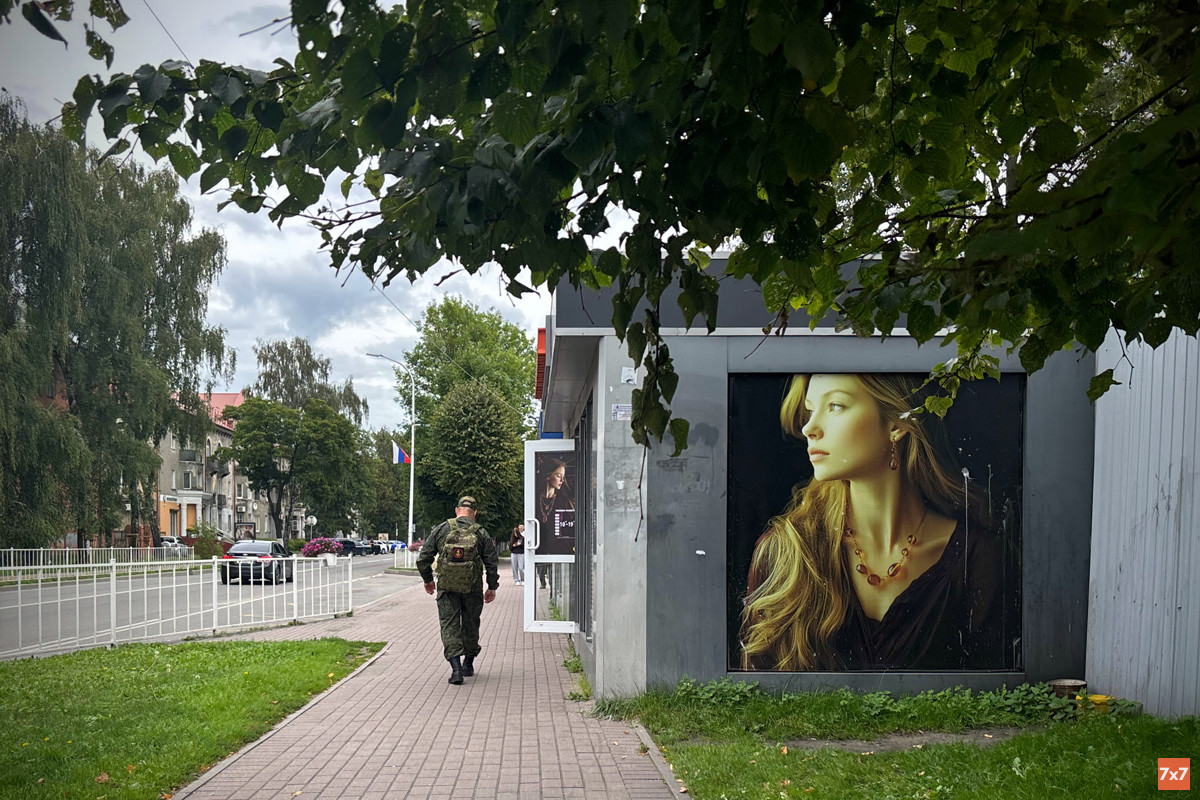 A serviceman walks toward a bus stop in central Baltiysk